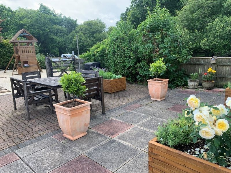 A garden upgrade in Brockenhurst. Addition of custom wooden planters and terracotta pots